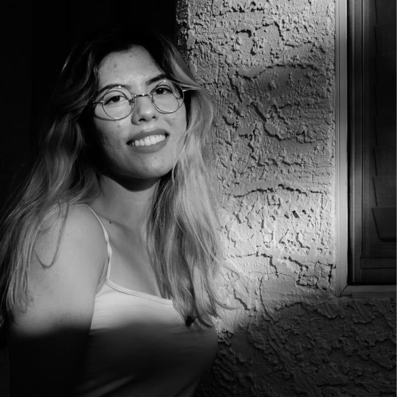 Gabriela Castillo-Londono smiling in a black-and-white portrait.